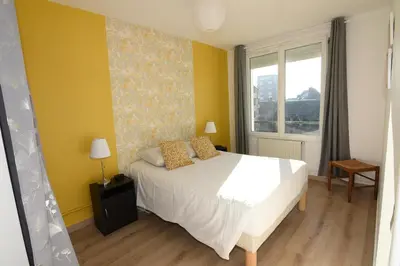 Un ou plusieurs lits dans un hébergement de l'établissement La Jetée Appartement Vue Mer