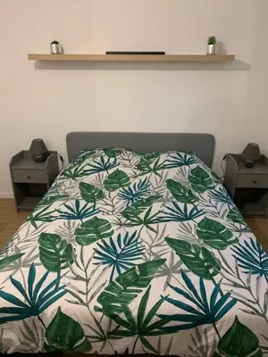 Un ou plusieurs lits dans un hébergement de l'établissement Logement à 20 min de Paris avec parking gratuit